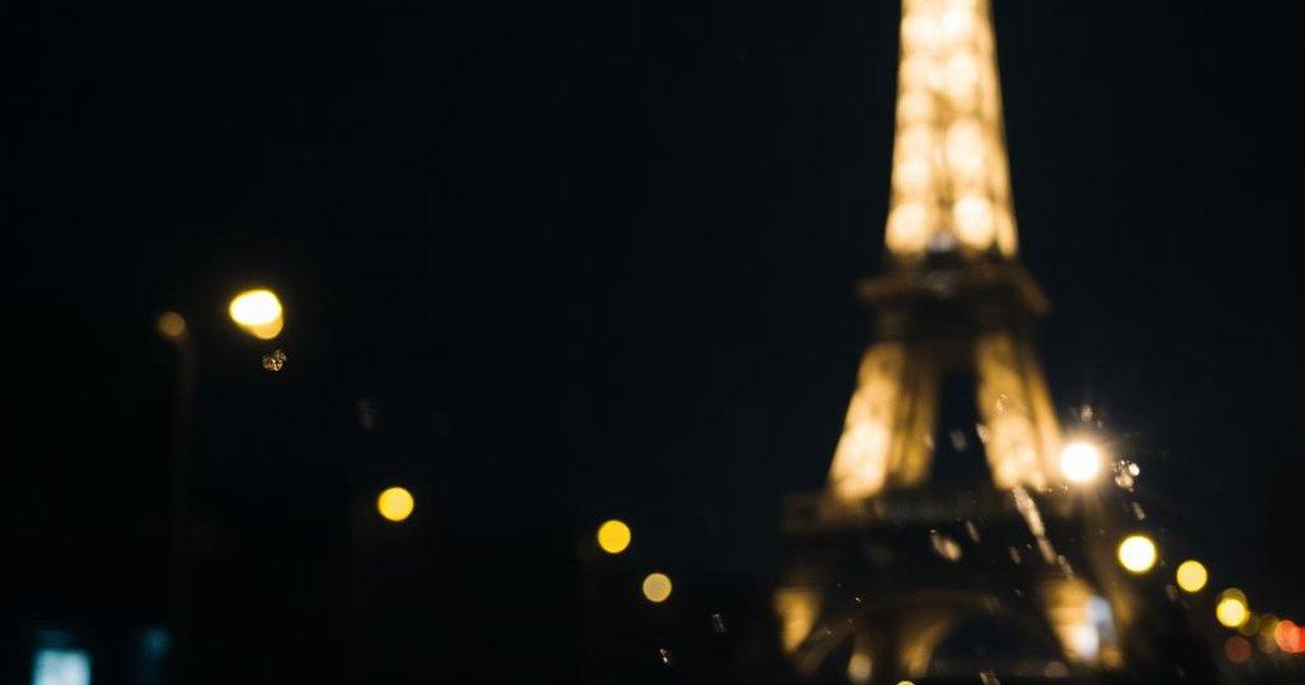 The Eiffel Tower above Paris rooftops in warm evening light